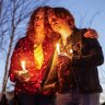 Dawn Markle and her son Evan Markle of Adair participate in a community candlelight vigil for Nex Benedict, an Oklahoma teenager who died the day after a fight in a high school bathroom in which the nonbinary student said they were a target of bullying, in Owasso, Oklahoma.