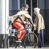 A cyclist on the corner of Bourke and Spring Street. 