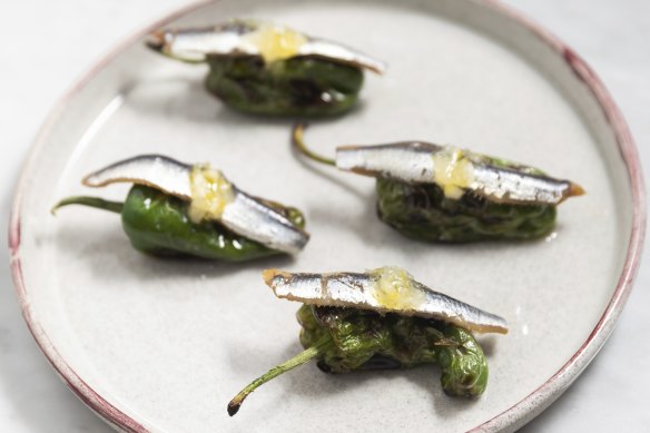 Grill-blistered peppers with anchovy and preserved lemon.