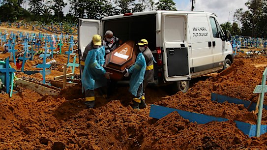 Cemetery workers carry the coffin of 89-year-old Abilio Ribeiro, who died of COVID-19, at a cemetery in Manaus, Brazil this month.