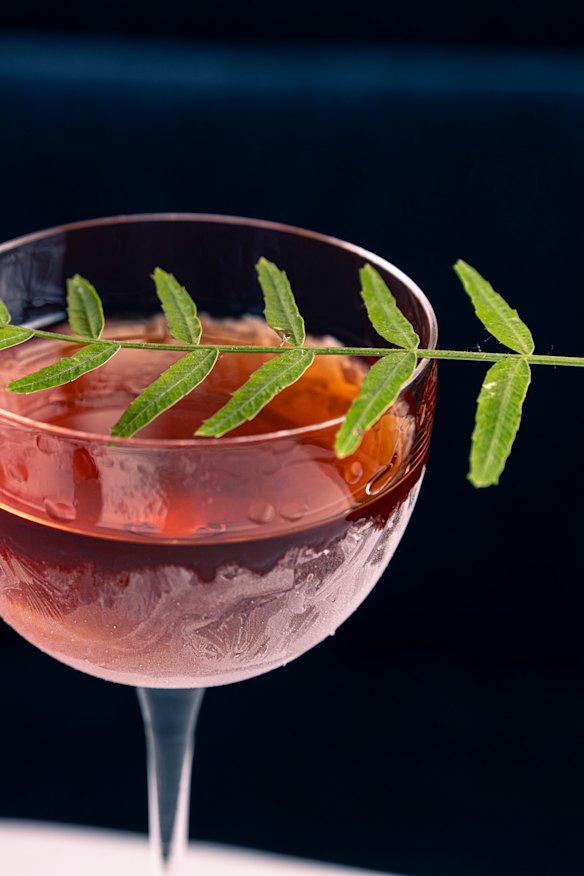 Go-to drink: Forest Forage martini garnished with pink peppercorn leaves.