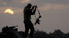 An Israeli soldier Stans on a tank as it is taking position in front of the northern Gaza Strip.