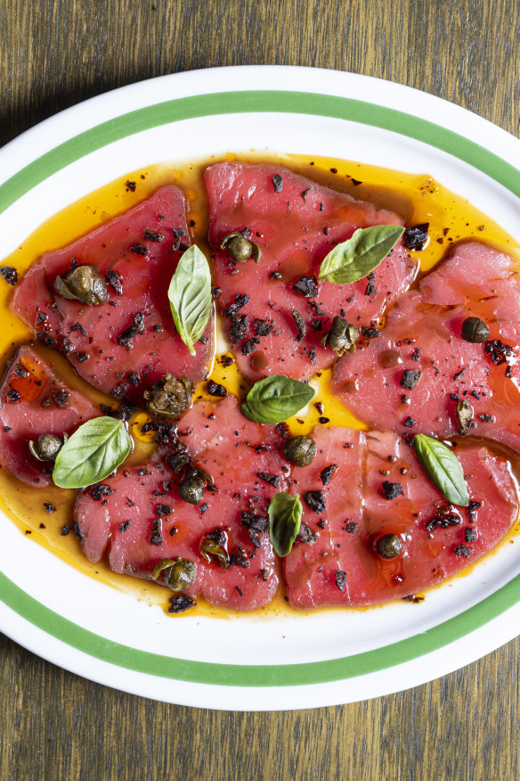 Tuna carpaccio with tomato, olive crumb and capers.