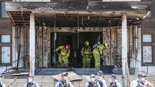 Firefighters responding at the fire-damaged front entrance of Old Parliament House following a protest in Canberra on Thursday.