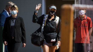 Naomi Osaka acknowledges the crowd before her first-round match against Patricia Maria Tig at the French Open. She quit the tournament shortly afterwards.