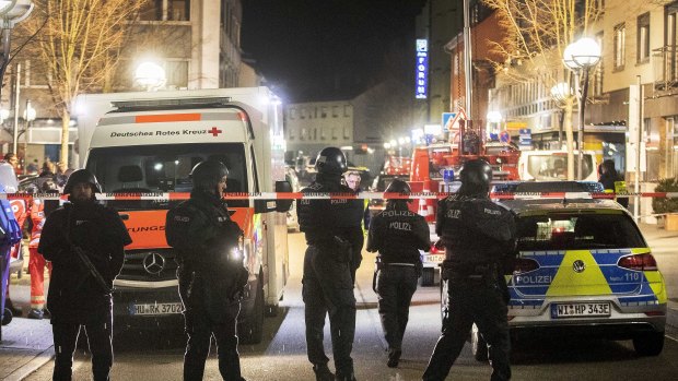 Police stand guard near the scene of a shooting in central Hanau.