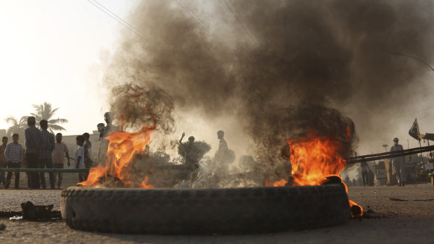 Pakistani protesters burn tyres while blocking a main road during a protest after a court decision to acquit the Christian of blasphemy charges.