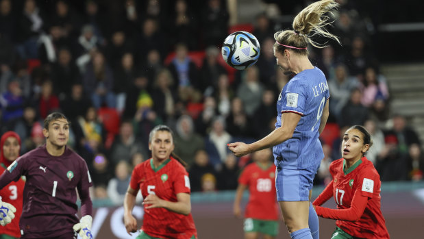 France’s Eugenie Le Sommer heads the ball to score her team’s fourth goal against Morocco.