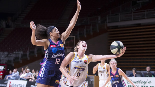 Lateral thinking: Melbourne Boomers captain Jenna O'Hea takes the ball to the basket against Adelaide's Nia Coffey.