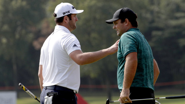 Form: Patrick Reed (right), alongside fellow professional John Rahm, holds the outright lead in China.