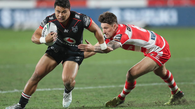Captain Gareth Widdop of the Dragons attempts to stop Mason Lino of the Warriors.