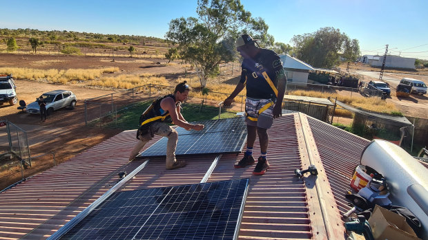 Andrew Dodd (right) learns the ropes on solar installation from Ben Hill at Tennant Creek.