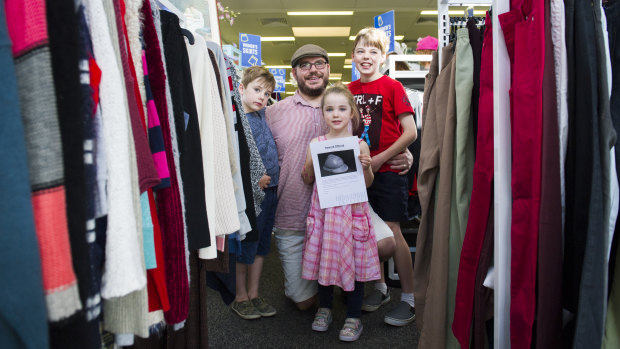 Igor Dopita, with his children Charlie Dopita, 7, Lyla Dopita, 4, and Lucas Dopita, 9, is offering a $500 reward for his great-grandfather's World War 1 helmet which was last seen at the Queanbeyan St Vincent de Paul store.