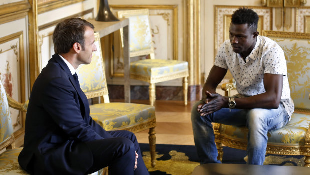 'Bravo': French President Emmanuel Macron meets with Mamoudou Gassama at the presidential Elysee Palace.