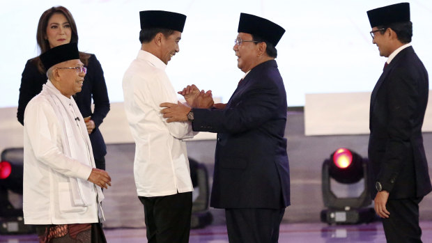 Indonesian President Joko Widodo, second left, with his running mate Ma'ruf Amin, left, and his contender Prabowo Subianto, second right, with his running mate Sandiaga Uno.