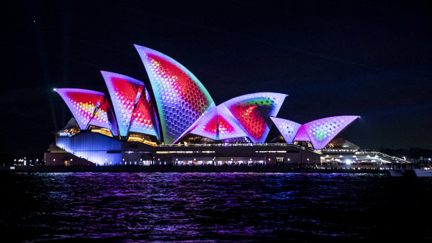 The Opera House Sails are lit for the 10th anniversary of Vivid on Friday night.