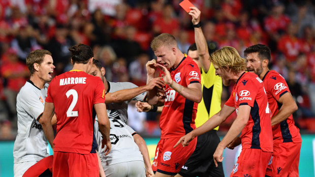 Insult to injury: Players clash after Stefan Mauk is injured and then given a red card.