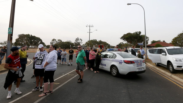 Residents are seen outside an exclusion zone as police detonate an explosive at a Davoren Park property.