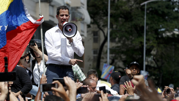 The leader of Venezuela's National Assembly Juan Guaido, who declared himself the country's interim president, speaks to supporters during a rally against the government of President Nicolas Maduro, in Caracas, Venezuela, on Saturday.