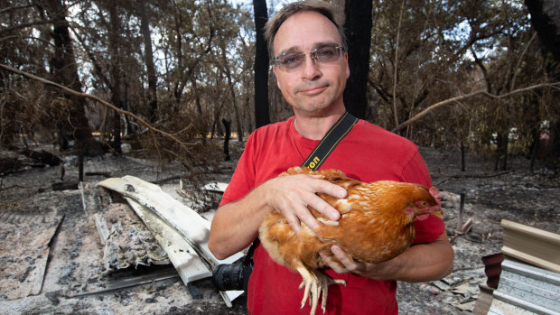 Thorsten Kels with one of his surviving chickens, Emma.