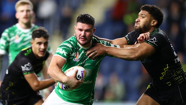 Ireland’s James Bentley breaks the tackle of Jamaica’s AJ Wallace to score a try during their Rugby League World Cup match in Leeds.