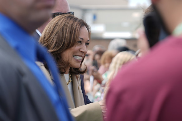 Vice President Kamala Harris greets supporters as she arrives at Westfield-Barnes Regional Airport in Westfield, Massachusetts.