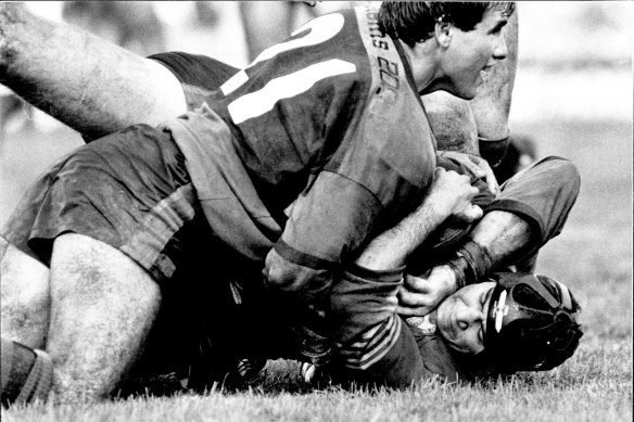 Jeff Fenech (on the bottom in head gear) is crunched in his rugby league debut for Parramatta Reserve Grade.