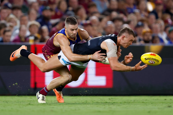 Josh Dunkley of the Lions and Patrick Cripps of the Blues.