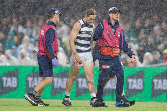 Tom Stewart is helped from the field on Saturday night.