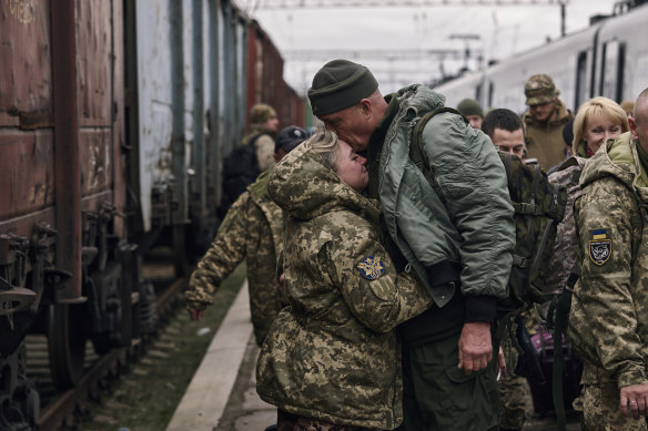 A Ukrainian woman soldier, left, hugs her husband as they meet at a railway station close to the frontline in Kramatorsk, Donetsk region, Ukraine, on Wednesday.