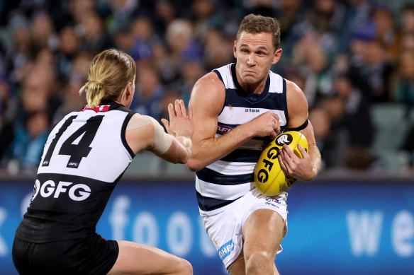 Joel Selwood braces for contact with Port’s Miles Bergman.