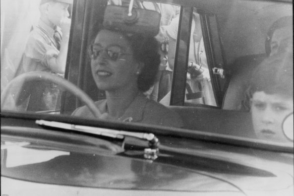 The Queen drives her children to a polo game at Windsor Great Park in 1956. Prince Charles is sitting beside her.