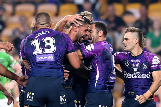 Cameron Smith celebrates Jesse Bromwich's first try against Canberra on Friday night.