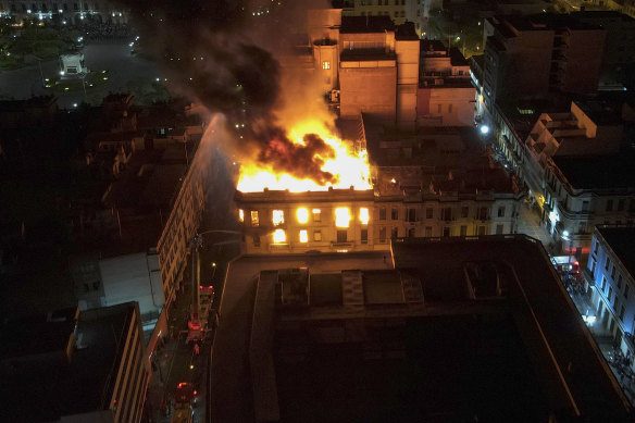 Perşembe günü Peru, Lima şehir merkezinde hükümet karşıtı protestolar sırasında bir bina yanıyor.