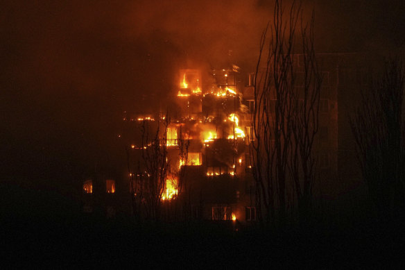 A fire burns at an apartment building after it was hit by the shelling of a residential district in Mariupol, Ukraine.