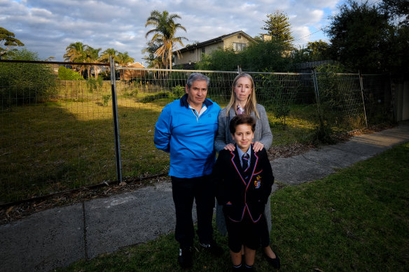 Angelo and Melanie Francese with son Patrick in front of the empty land next to their home in Beaumaris. 