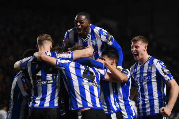 Sheffield Wednesday’s Josh Windass is mobbed by teammates after scoring the Owls’ FA Cup winner over Newcastle.