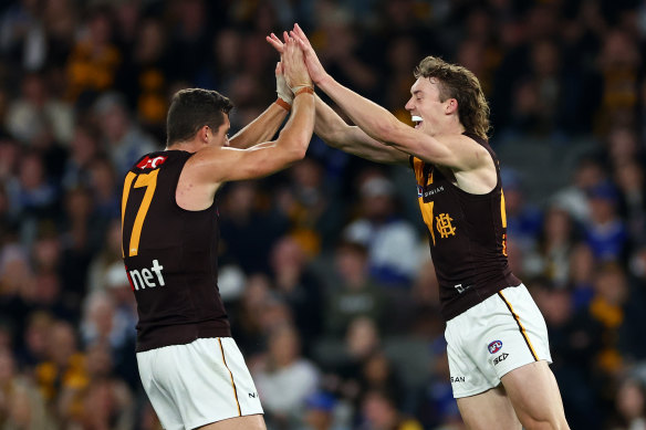 Hawthorn celebrate a goal.