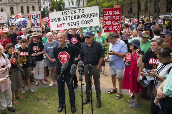 Brown, flanked by businessman Geoffrey Cousins, addresses a rally in Brisbane to protest against the proposed Adani Carmichael coalmine.