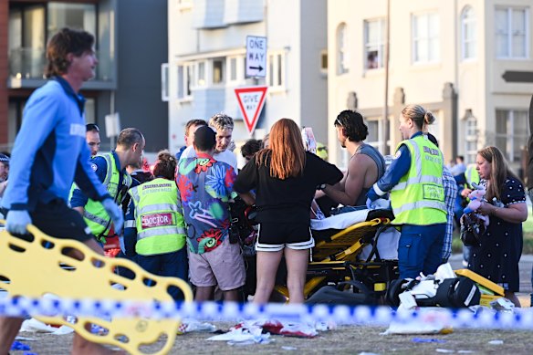 Emergency workers help some of the wounded at Bondi Beach.