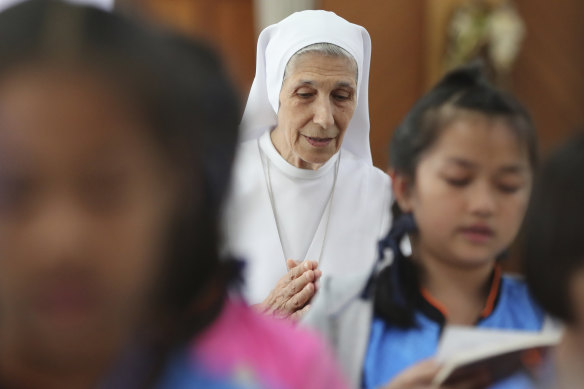 Sister Ana Rosa Sivori and students pray inside a church in Udon Thani, about 570 kilometres north-east of Bangkok, Thailand. 