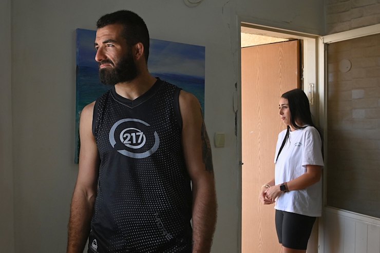 Rafael Aronov and his wife, Lior Aronov, stand in their Beersheba home.
