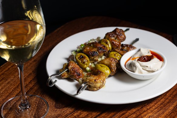Char-grilled spiced chicken and green olive skewers.