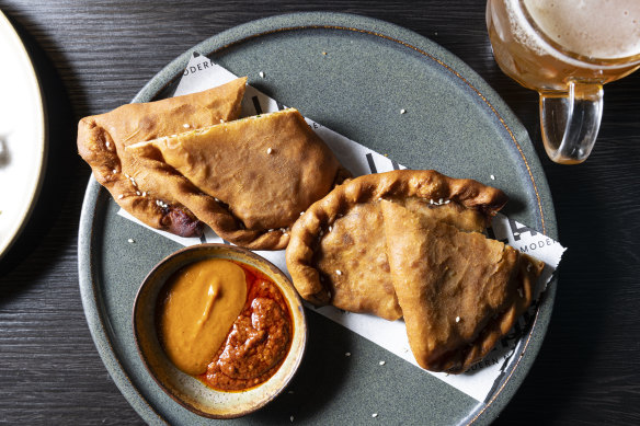 Shaphaley (fried flatbread stuffed with chicken mince and cabbage) served with hot sauce.