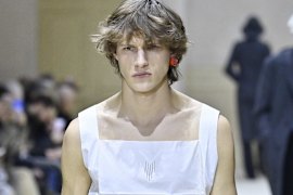 Delicate cottons and bold earrings on the Prada runway in Milan.