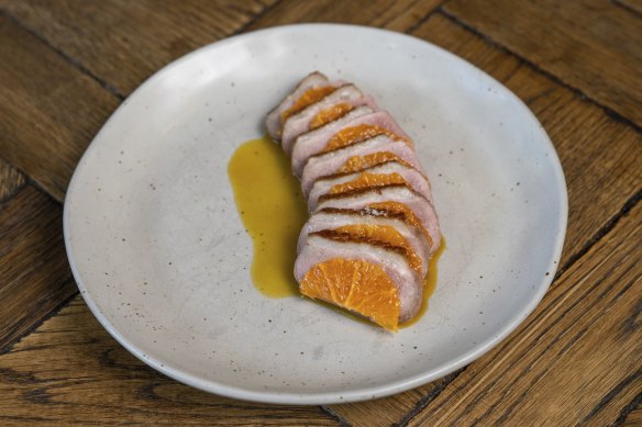 Slices of rosy Wimmera duck breast are interleaved with mandarin segments.