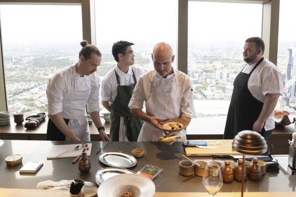 Executive chef Michael Greenlaw (second from right) at the bar, which doubles as an open kitchen.