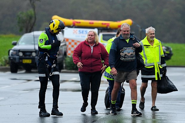 Rescued: Oaxley Island residents Liz Brennan, her husband Paul Brennan (second from right) and a neighbour (right).