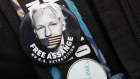 Badges worn by a demonstrator outside Westminster Magistrates Court in London.