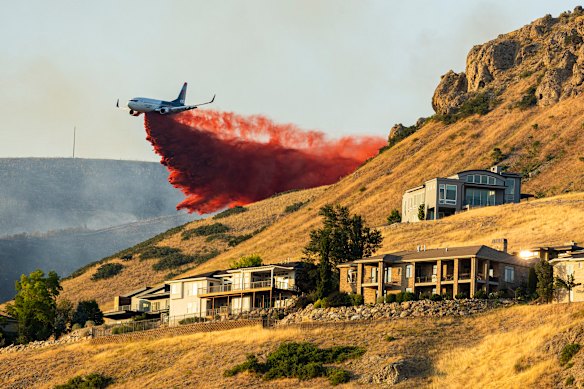 A plane drops fire retardant as the Sandhurst Fire burns above Ensign Peak north of Salt Lake City, USA.